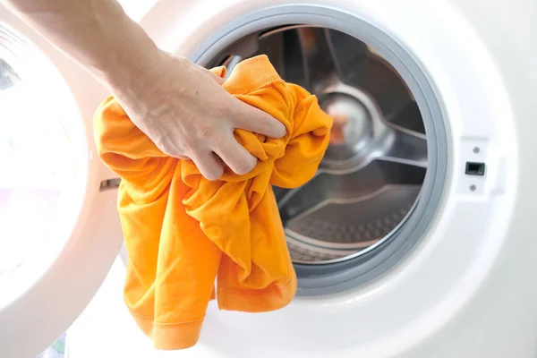 man's hand Pick up clothes Washing machine.Clean and Healthy Concepts