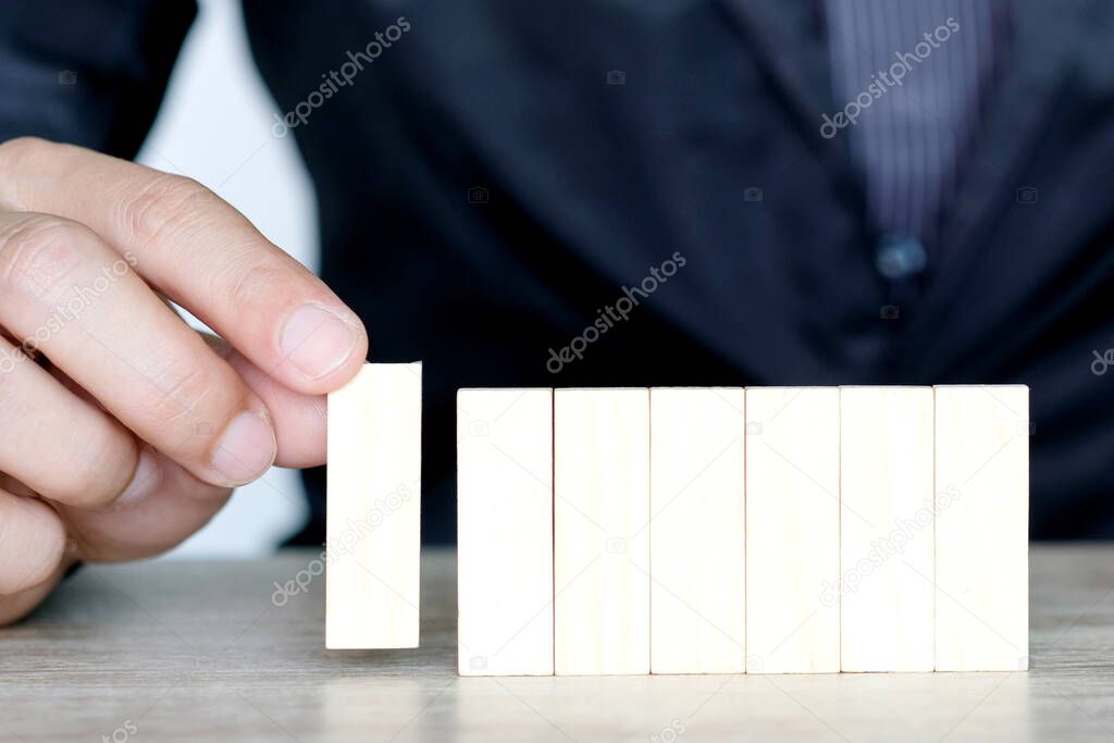 Steps of success for business or investment. Business man is arranging wood block to increase high, Business concept , Investment concept of successful.