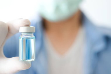 Doktor eli, elinde bir şişe antiretroviral ilaç tutuyor, mavi su. Sağlık ve tıbbi kavramlar