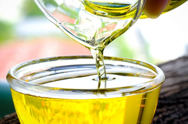 Olive oil in a glass bowl. Good fats. Prepared for cooking ideas. Health care.