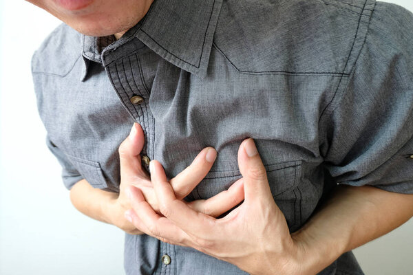 Heart attack, Man standing chest pain in the bedroom Health concept