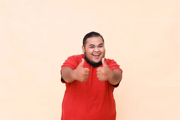 Young Asian Fat Man Wearing Red Shirt Isolated Background Smiling — стоковое фото