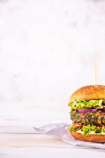 Beyaz bir masada vejetaryen burger ve beyaz bir arka plan. Sebze eti. Yemek hazır.. 