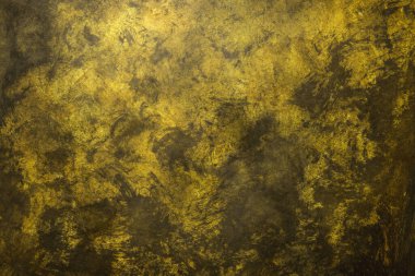 Yellow weathered wall textured background with golden tones. Aged wall.