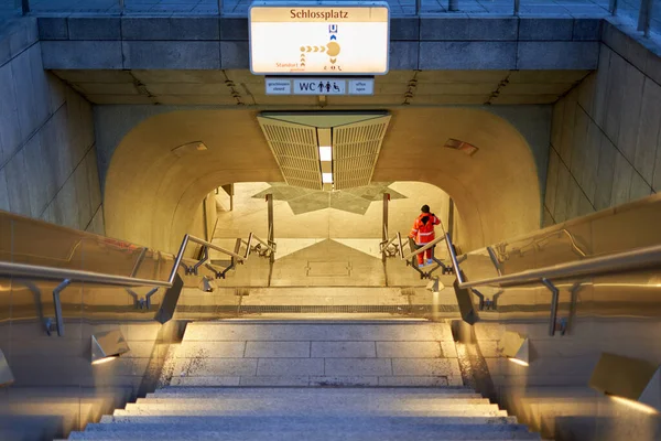 Metro istasyonuna iniyor. Toplu taşıma için aydınlatılmış çıkış. Konumla imzala. Şehir temizleme işçisi Almanya, Stuttgart, Schlossplatz.