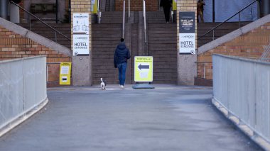 Stuttgart, Almanya - 06 Ocak 2022: Corona hızlı kontrol antijeni için test alanı ayrıca pcr. Genç bir kadın köpekle yürüyor. 2G + kuralları deneniyor.