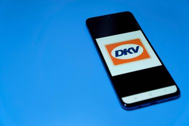 Stuttgart, Germany - April 10, 2022: Smartphone with fuel price app (DKV). Cheap refueling with expensive gas, and energy costs. Isolated on blue.