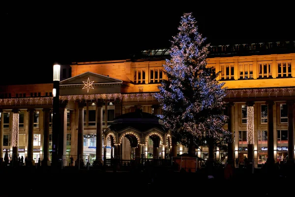 Stuttgart, Germany - December 31, 2021: Shopping center decorated for Christmas. Klett passage at night. Illuminated fir tree and pavilion.