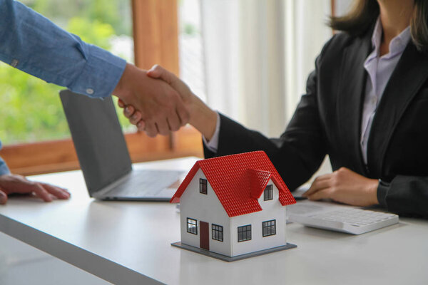 Guarantees, Mortgages, Signings, contract, agreement concept, Real estate agents shake hands with clients after signing the contract and congratulate them after reaching an agreement.