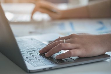 Marketing, Finance, Accounting, Planning, Businesswomen use calculators, computers, and graphs to analyze work to make the company profitable.