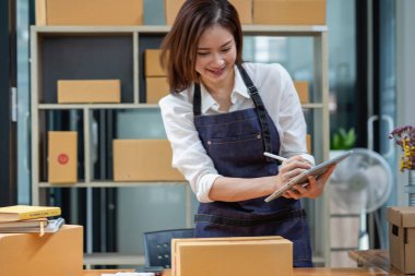 Online sales woman business owner Receive orders and deliver products with boxes to customers. Online SME business concept.