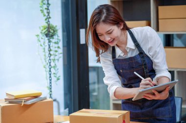 Online sales woman business owner Receive orders and deliver products with boxes to customers. Online SME business concept.