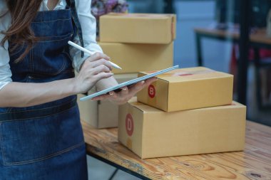 Online sales woman business owner Receive orders and deliver products with boxes to customers. Online SME business concept.