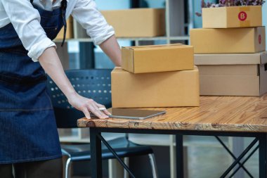 Online sales woman business owner Receive orders and deliver products with boxes to customers. Online SME business concept.