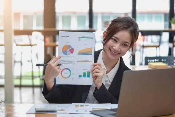 Marketing, Financial, Accounting, Planning, Business women analyze company results and profits with graph statistics. Use a laptop computer and a calculator to calculate the company's balance.