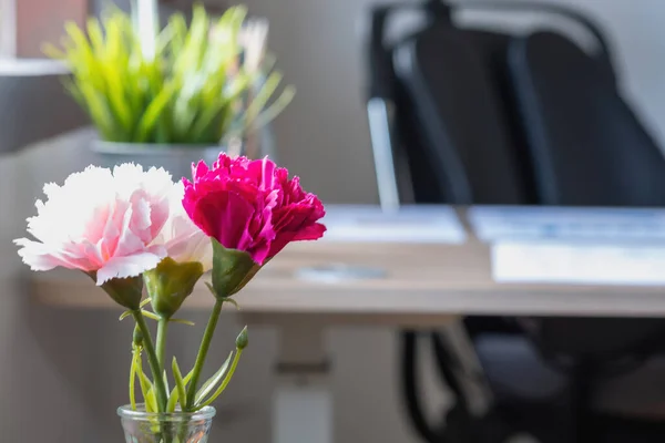 Pink fake flowers that decorate the office