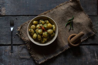 Top view of aloo dum or fried baby potatoes in a bowl.