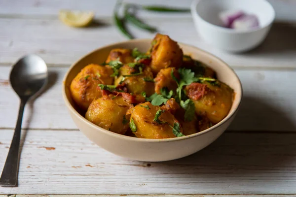 Popular Indian food item dum aloo or potato masala gravy in a bowl. Close up, selective focus.