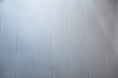 White brick pattern background with use of selective focus. Useful for designing purposes.