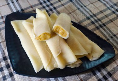 Patishapta is a type of pithe. It is a light crpe filled with either kheer or a coconut and gur mixture