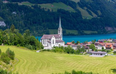 Güneşli bir günde İsviçre köyündeki gotik bir kilisenin manzarası. Akciğer. İsviçre.