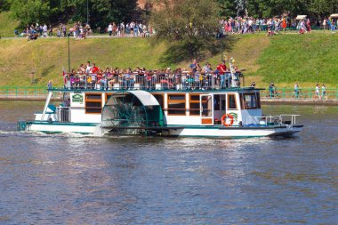 Krakow, Poland - July 17, 2022: A group of tourists on a pleasure boat on a sunny day.