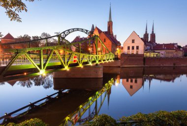 Green iron bridge to Tumsky island in the night illumination in the early morning. Wroclaw. Poland.