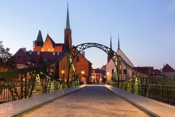 Green iron bridge to Tumsky island in the night illumination in the early morning. Wroclaw. Poland.