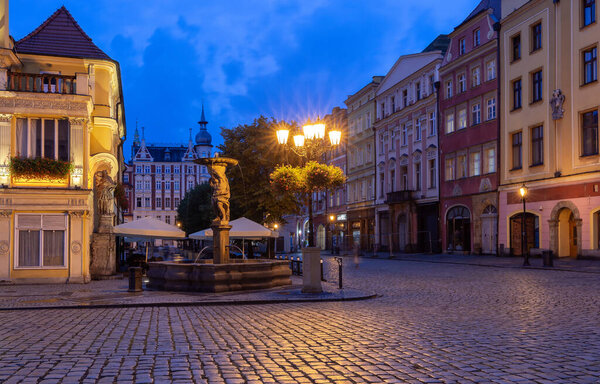 View of the old medieval market square and the facades of traditional colorful houses at dawn. Swidnica. Poland.