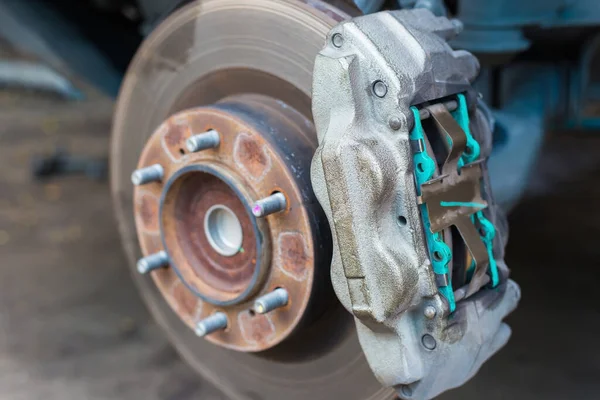 Maintenance repair and cleaning disc brake and asbestos brake pads it's a part of car use for stop the car for safety at front wheel this a new spare part for repair at car garage