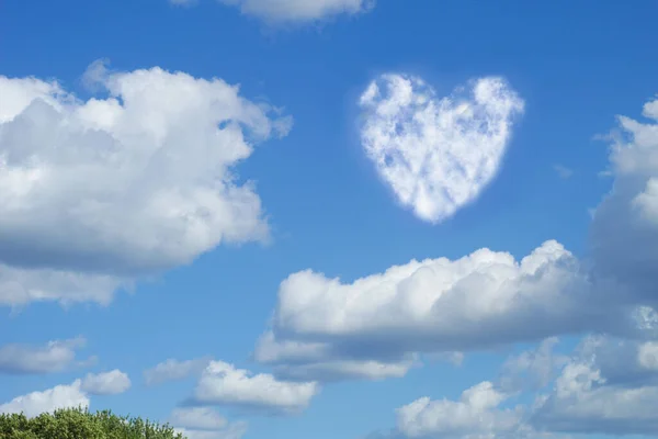 Clouds in the form of a heart in the blue sky. Romantic sky and clouds in the shape of a heart on a blue sky background