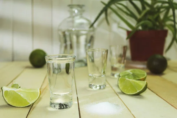 Tequila with lime and salt on a wooden background. Tequila shot. Mexican tequila. Alcoholic drink, background with copy space