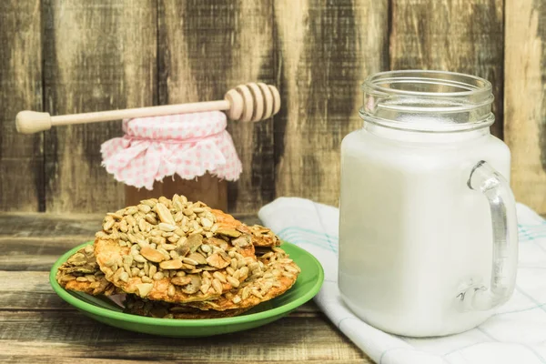 Useful cookies and milk and backgrounds copy space. Homemade cookies next to a jar of milk. Country style