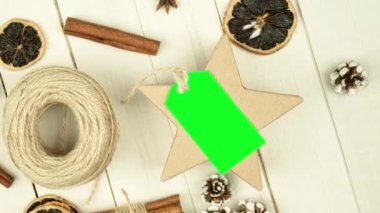 Box with twine and tag, background with copy space. Chroma key. Christmas card. View from above. Copy space - image. Camera zoom
