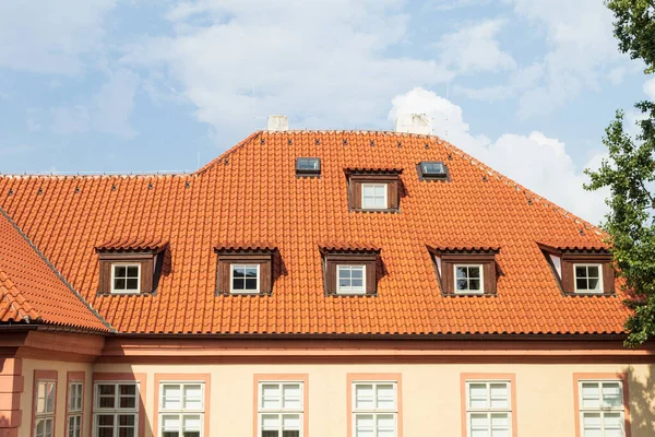 Tiled, red roof on old houses, close-up. Background of the old city and red roofs