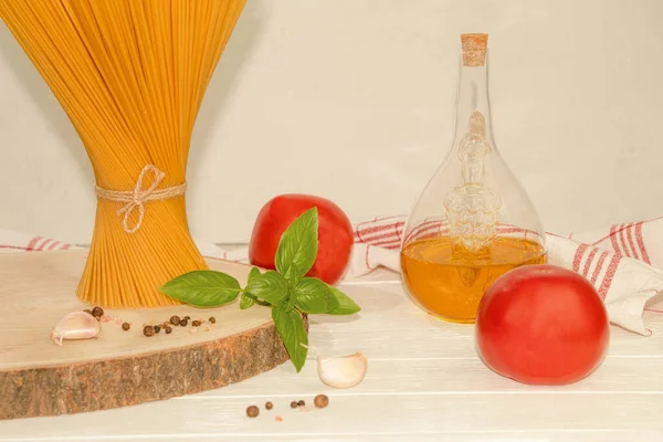 On the table is a pack of spaghetti tied with string. On a light background. Background with copy space