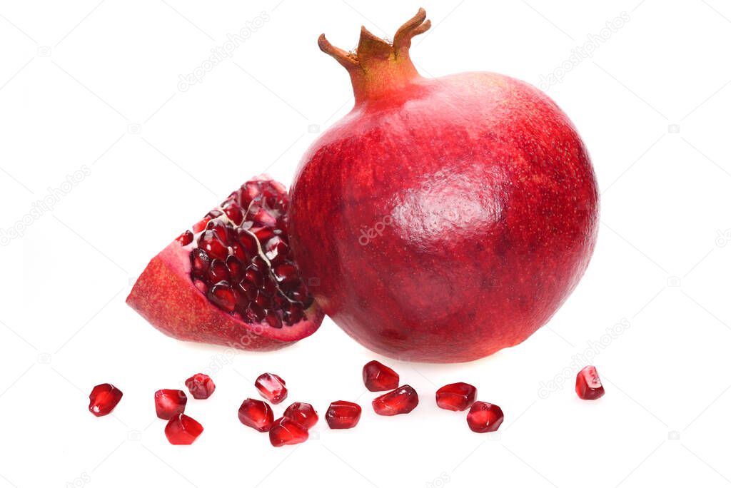Ripe pomegranate whole fruit with slice and seeds isolated on a white background in close-up