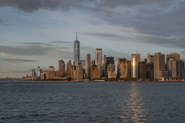 Ferry to Manhattan. View of Manhattan from the water at sunset, 