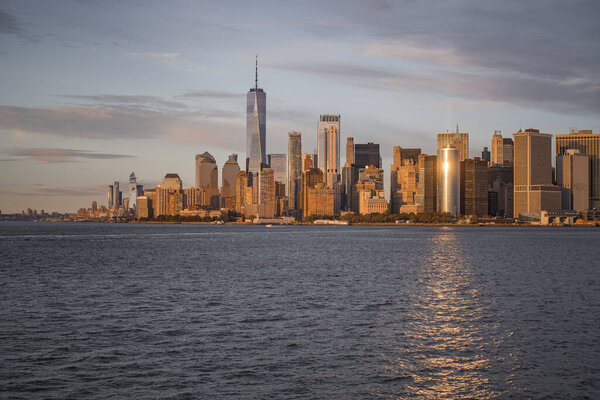 Ferry to Manhattan. View of Manhattan from the water at sunset,