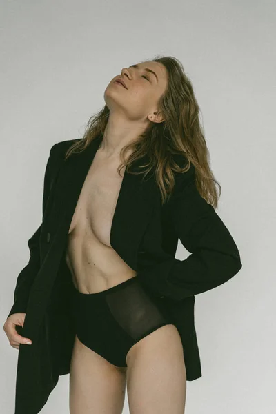 裸の体の上にジャケットを着た若い美しいブロンドの女性 スタジオ — ストック写真