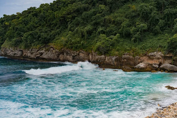 熱帯雨林 青い水のビーチ 波が石に打ち寄せる — ストック写真