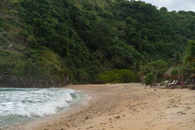 Tropik sahil manzarası, deniz taşları ve turkuaz okyanus, mavi gökyüzü..