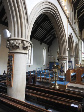 View of the interior of the church with numerous architectural arches and benches