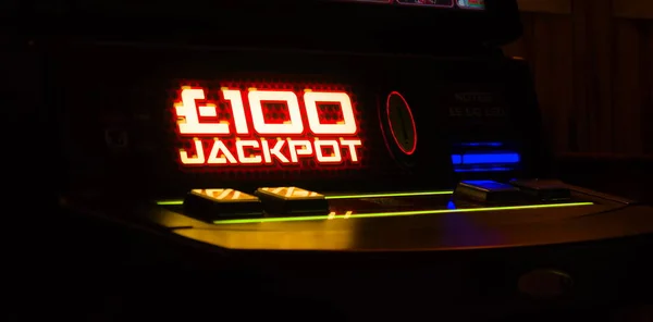 Jackpot sign lit up on gaming machine in a bar