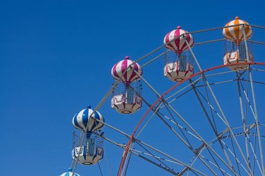 Mavi gökyüzüne doğru bir dönme dolap yakın 