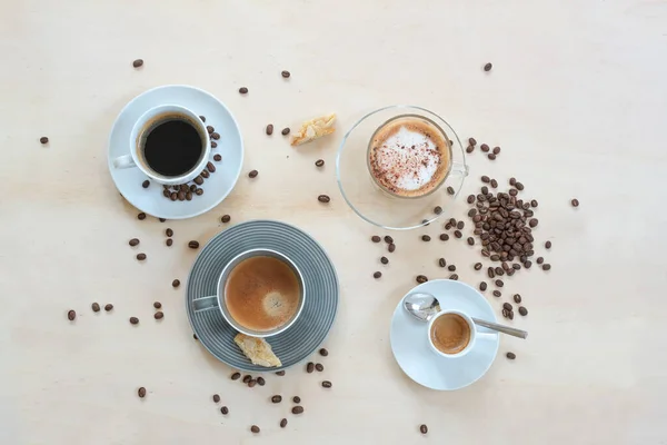 Four Cups Various Coffee Cappuccino Espresso Lungo Black Crema Cookies — Stock Photo, Image