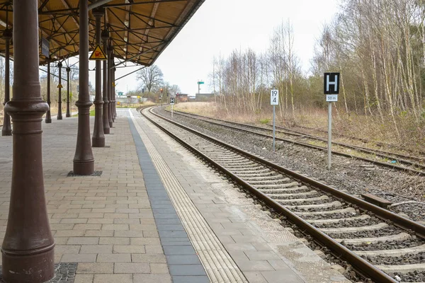 德国梅克伦堡小国家车站铁路轨道上覆盖着老式金属柱的月台 选定的重点是狭窄的地面深度 — 图库照片
