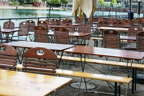 Empty chairs and tables in an attractive outdoor restaurant on the banks of the rhine, staff shortage after the corona pandemic becomes problematic for gastronomy