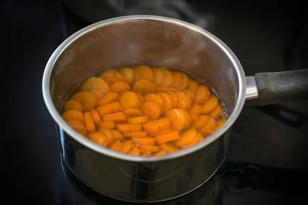 Slices Carrot Cooked Water Steel Pot Black Stove Healthy Digestible — стоковое фото