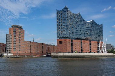 Hamburg concert hall Elbphilharmonie and modern brick buildings of the warehouse city, famous landmark and tourist destination on the river Elbe in Germany, blue sky, copy space